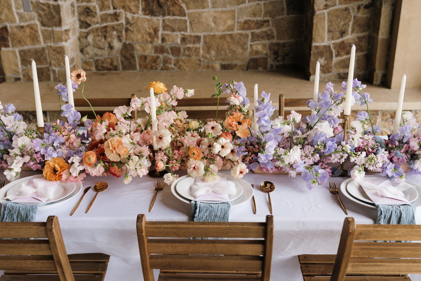 Colorful table centerpiece at Chateau de Lis with garden-inspired florals and refined spring styling.