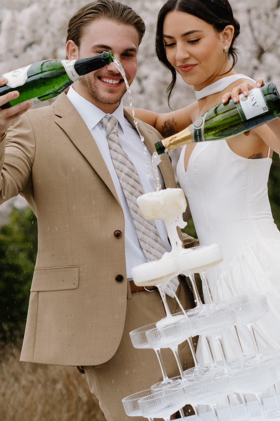 Close up of the bubbly pouring into each cup in the champagne tower.
