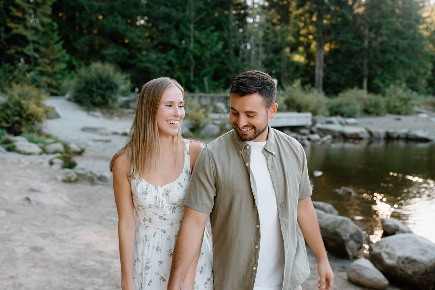 Relaxed couple sharing a quiet moment together with trees and water nearby during Trillium Lake engagement photos.