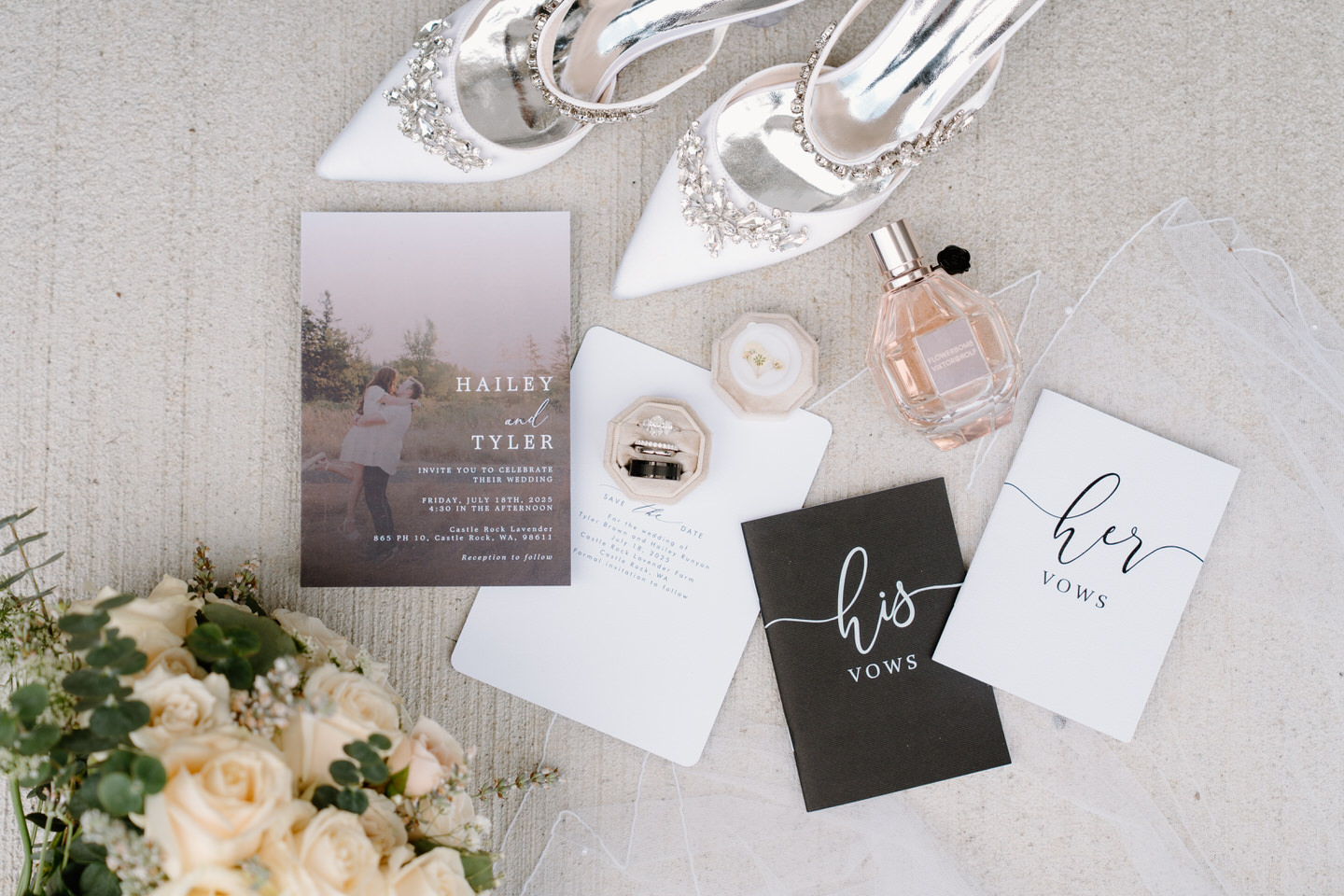 Wedding detail flat lay with invitation, vow books, rings, bouquet, and silver heels.