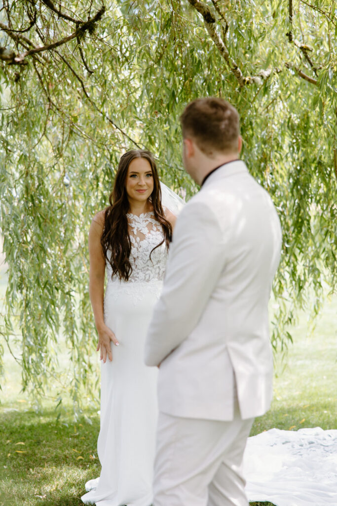 Bride and groom see each other for the first time under the willow tree at Castle Rock Lavender Farm. 