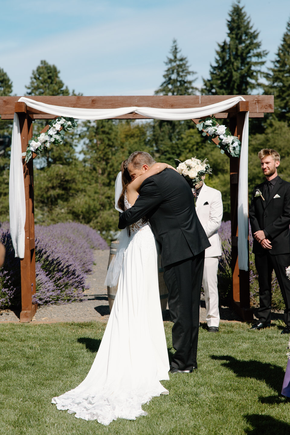Bride and her father hug at the front of the altar during Castle Rock Lavender wedding ceremony.