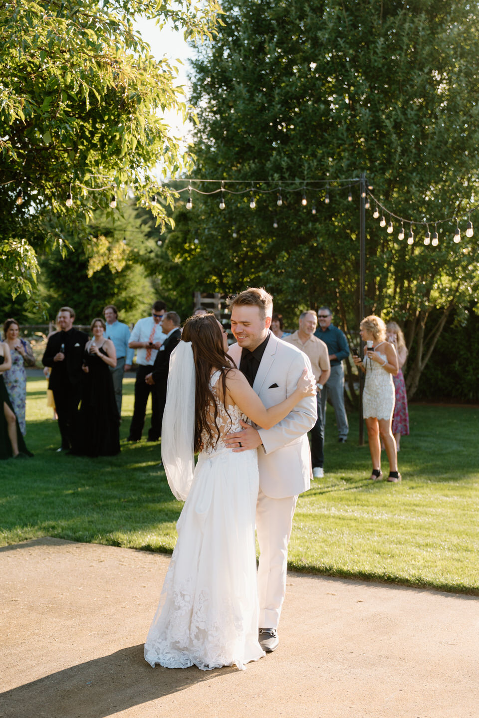 Hailey and Tyler sharing their first dance on the lawn.
