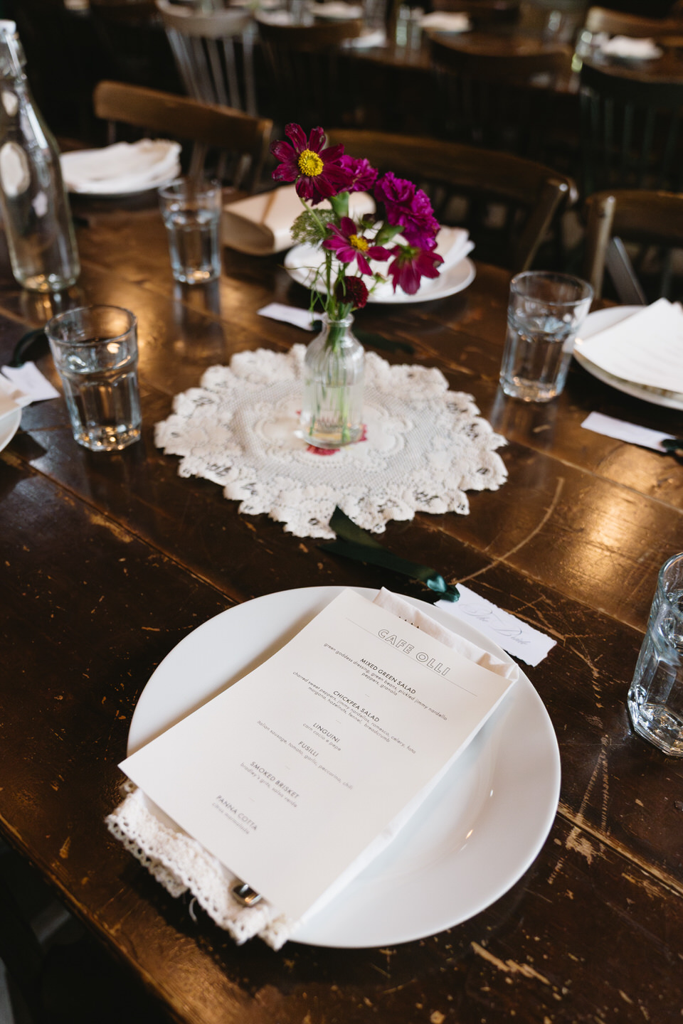 Reception table detail with florals, candles, and menus styled for a romantic fall Portland wedding dinner.