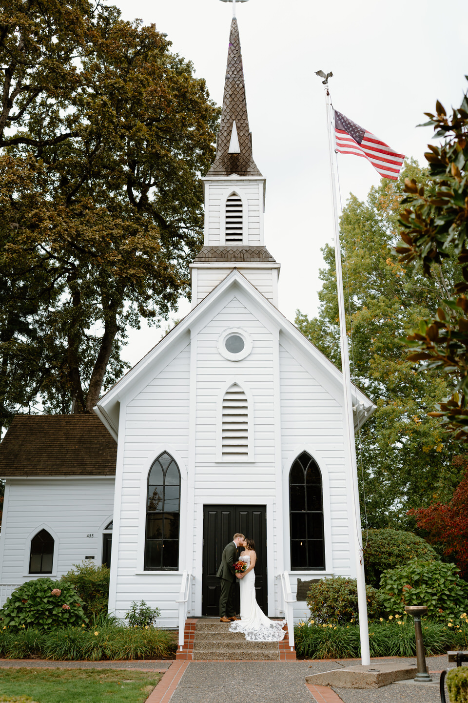 Classic view of the historic white chapel and steeple during a romantic Oaks Pioneer Church wedding in Portland.