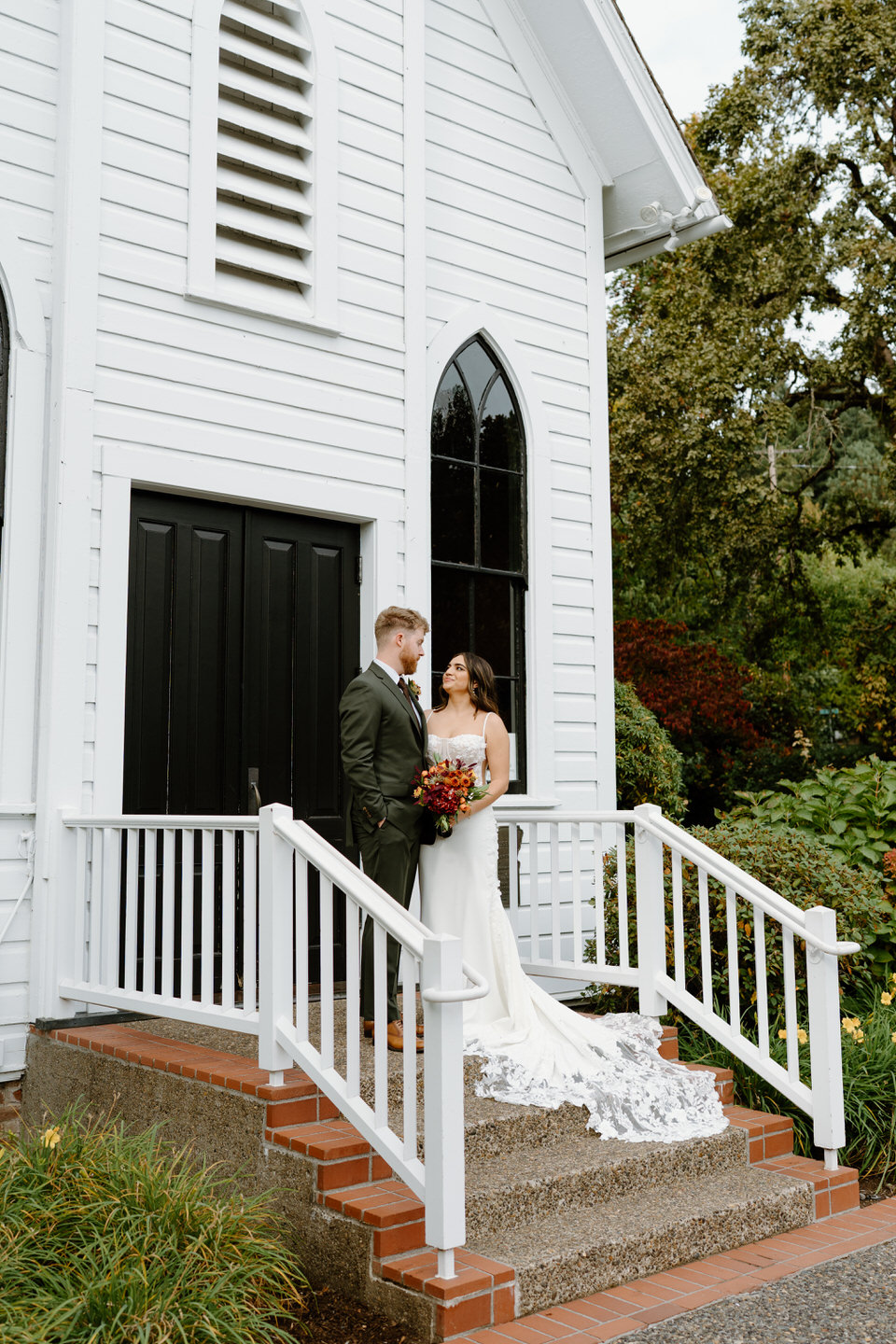 Teagan and Cameron pose on the steps outside the small white chapel in SE Portland.