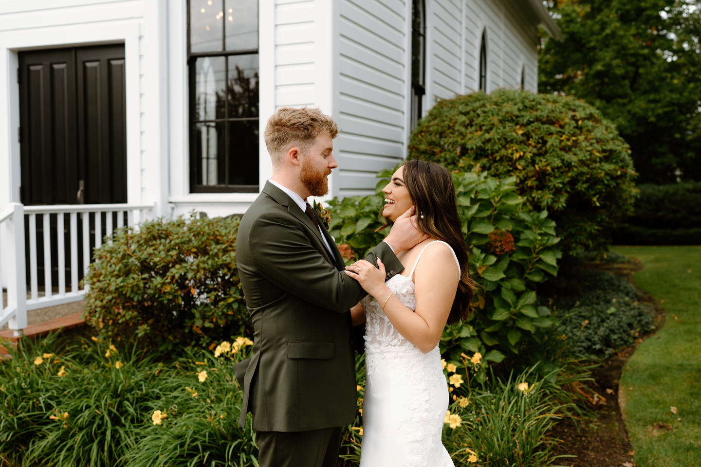 Groom gently holding bride’s hands during portraits outside the chapel at their romantic Portland Oregon wedding.