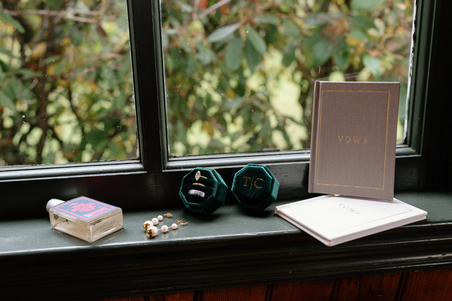 Flat lay of wedding details including rings, invitation suite, and accessories for a romantic fall Portland wedding.