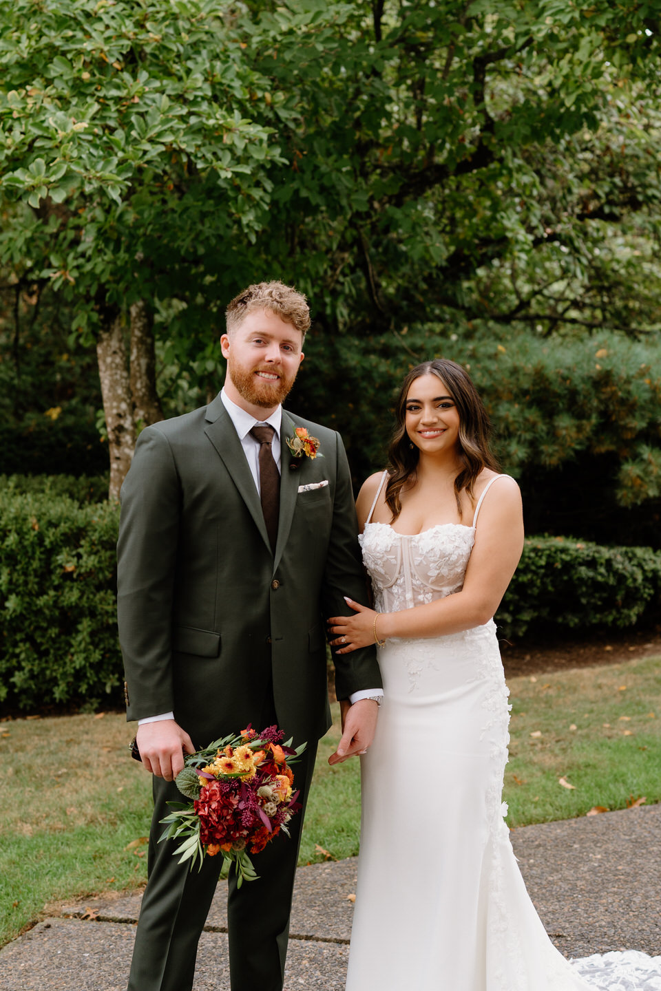 Newlyweds standing together smiling after their ceremony during a joyful Oaks Pioneer Church wedding.