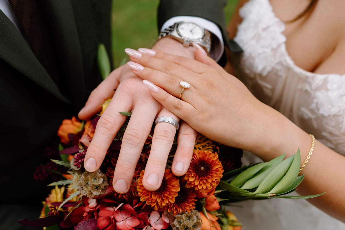 Close-up of bride’s wedding ring resting on vibrant autumn bouquet during a romantic fall Portland wedding.
