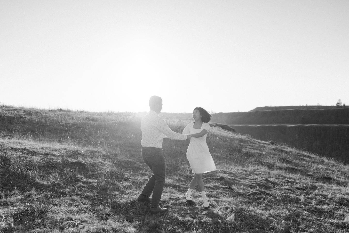 Black and white photo of a couple dancing in the sunlight at Rowena Crest.
