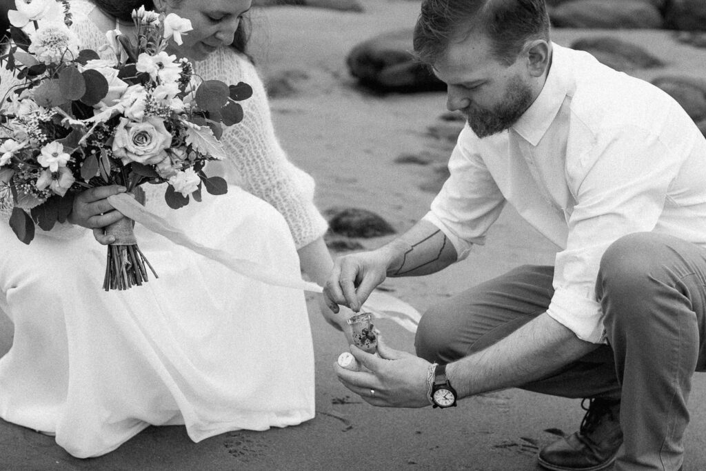 Collecting sand from Oregon Coast Elopement