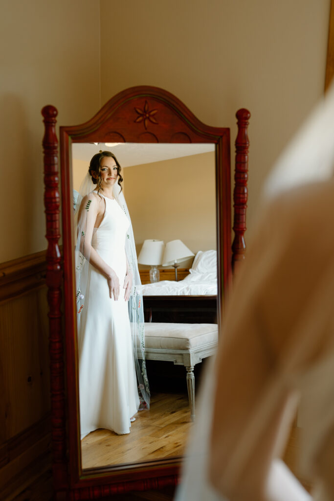 Bride looking in the mirror at Scholls Valley Lodge