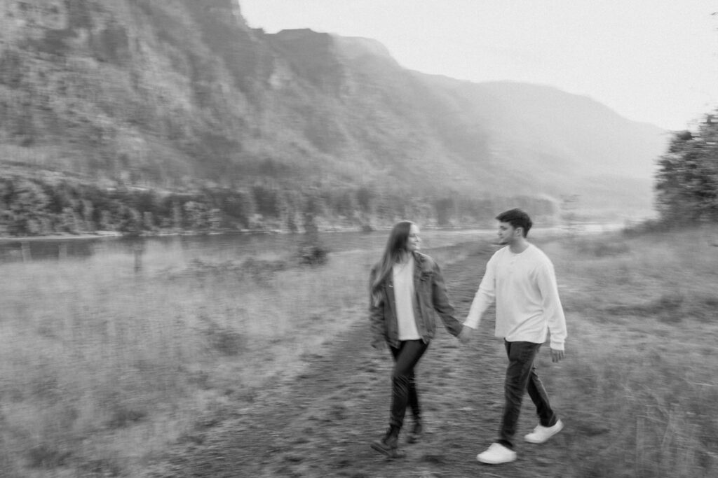 black and white photo of a couple walking in the columbia gorge