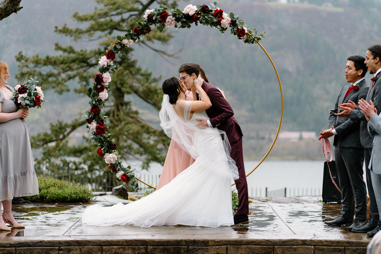 Bride and groom share their first kiss at Columbia Gorge Hotel wedding ceremony.