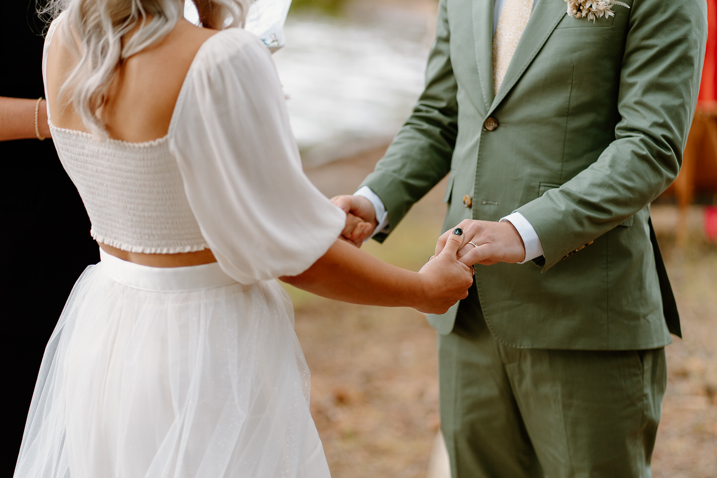 Holding hands during intimate ceremony at Suttle Lake