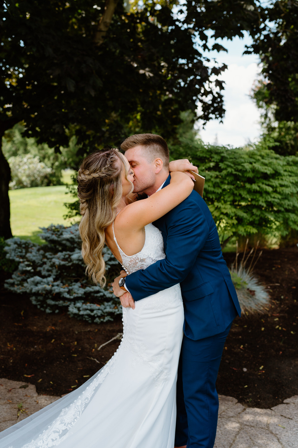 bride and groom kiss after seeing each other for the first time on wedding day
