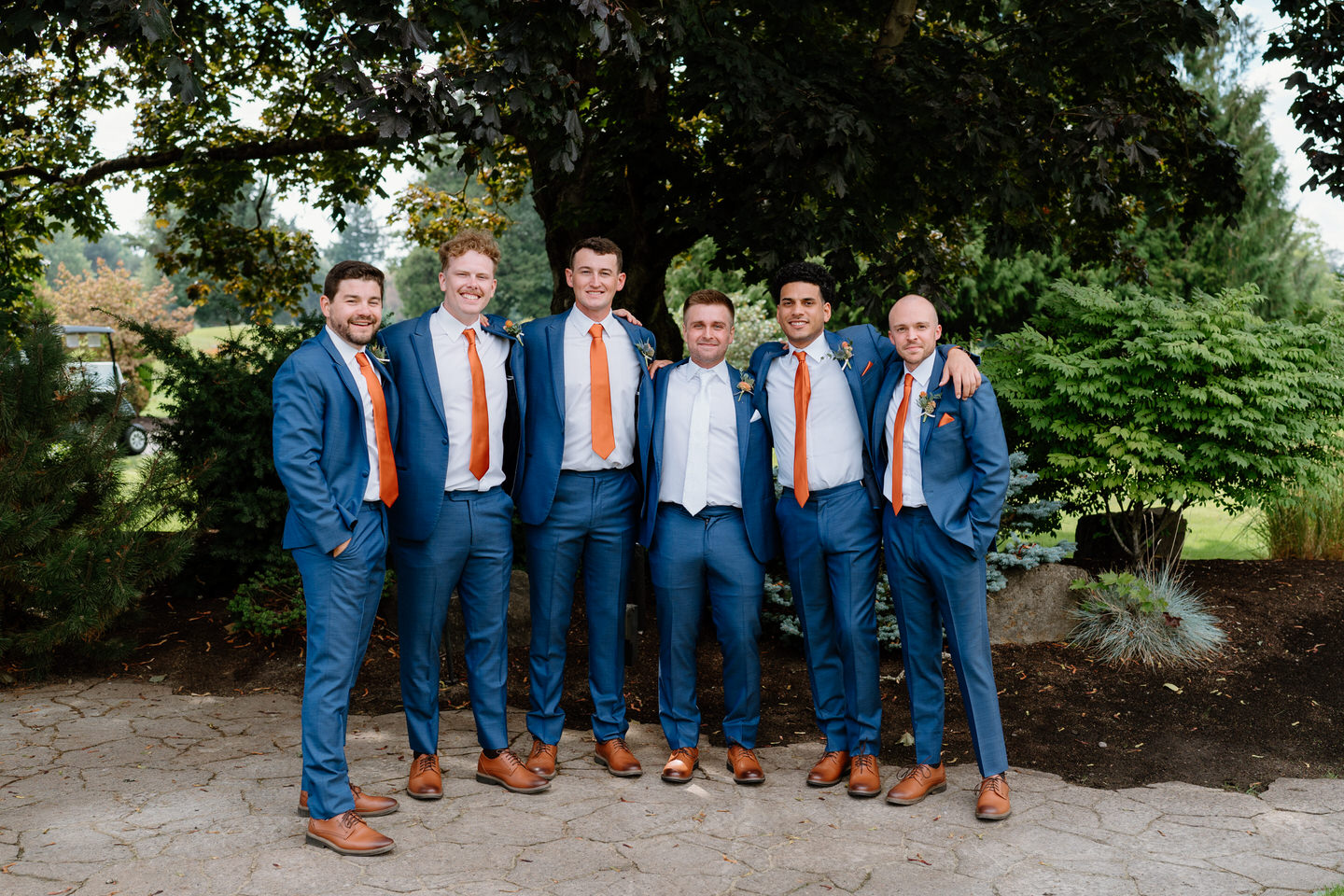 Groom and groomsmen smiling for formal portraits during Eugene, OR wedding
