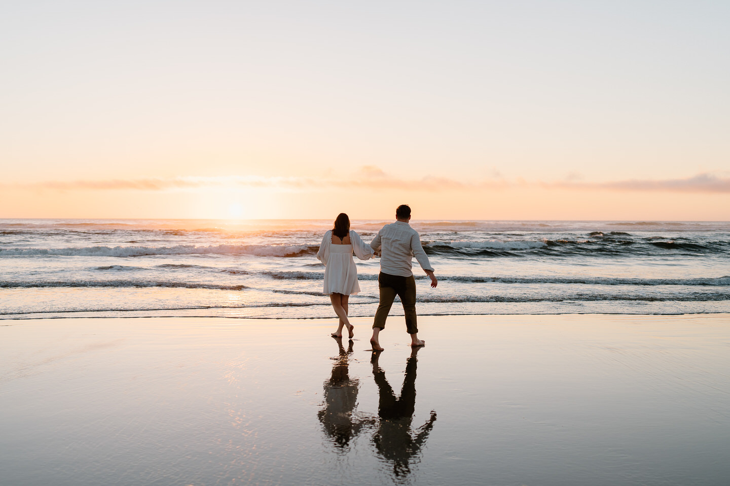 couple walking into the sunset on the beach