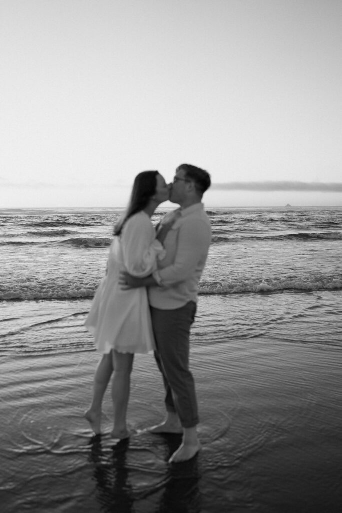 blurry photo of couple kissing standing in the water
