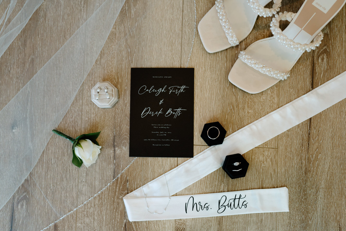 wedding day details of veil, invitation, and rings