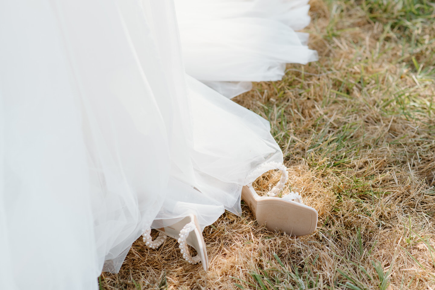 bride's shoes lay in the grass