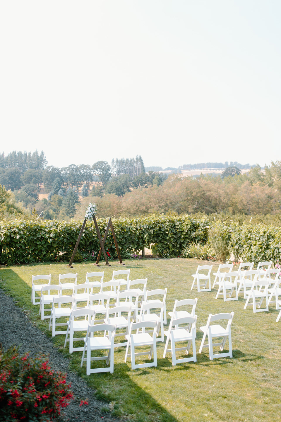 perryhill events wedding in the garden. set up with chairs and triangle arch