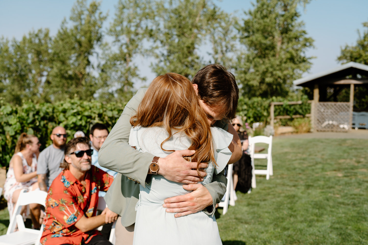 groom and mother hug during wedding ceremony