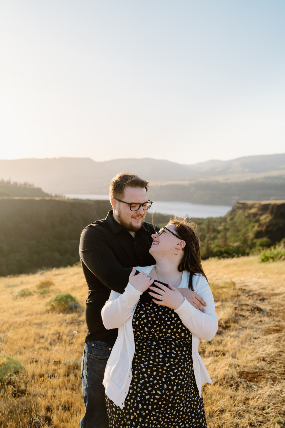 couple embraces for engagement photos in columbia gorge