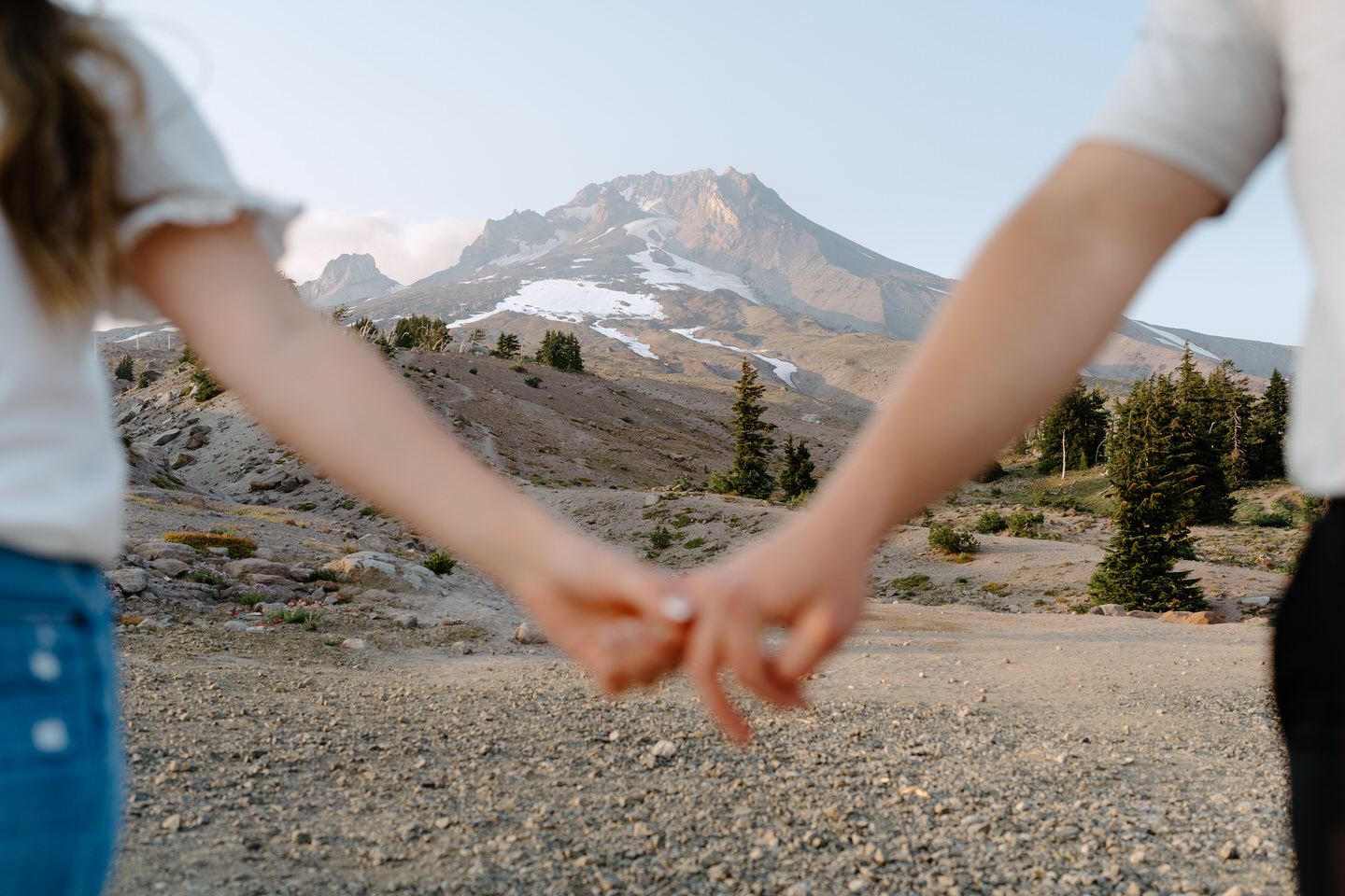 out of focus holding hands photo during mt hood couples session