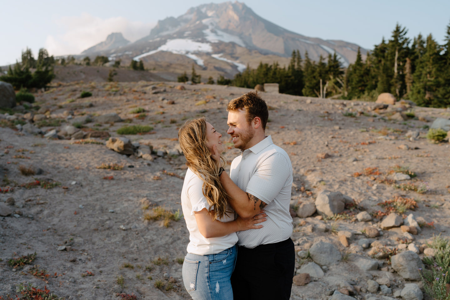 couple looking at each other with mt hood behind