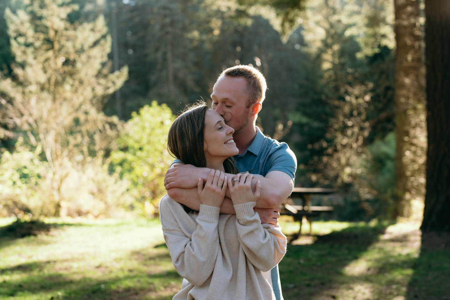 man kisses woman on cheek during Portland engagement session
