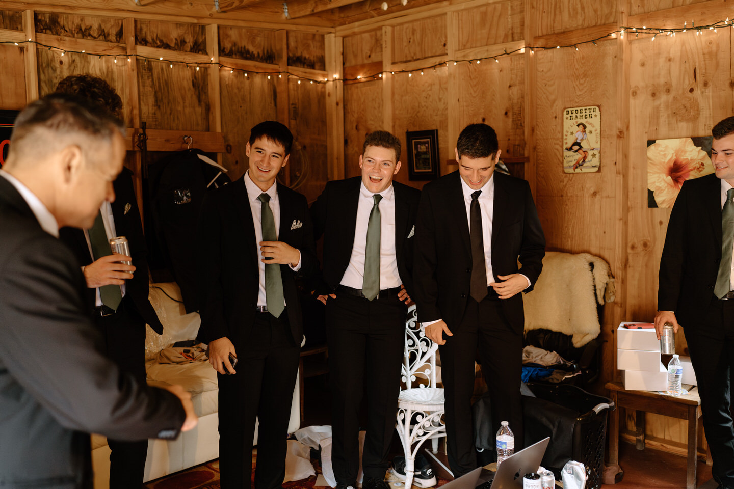 Groom and groomsmen getting ready together in the suite at Navarra Gardens.