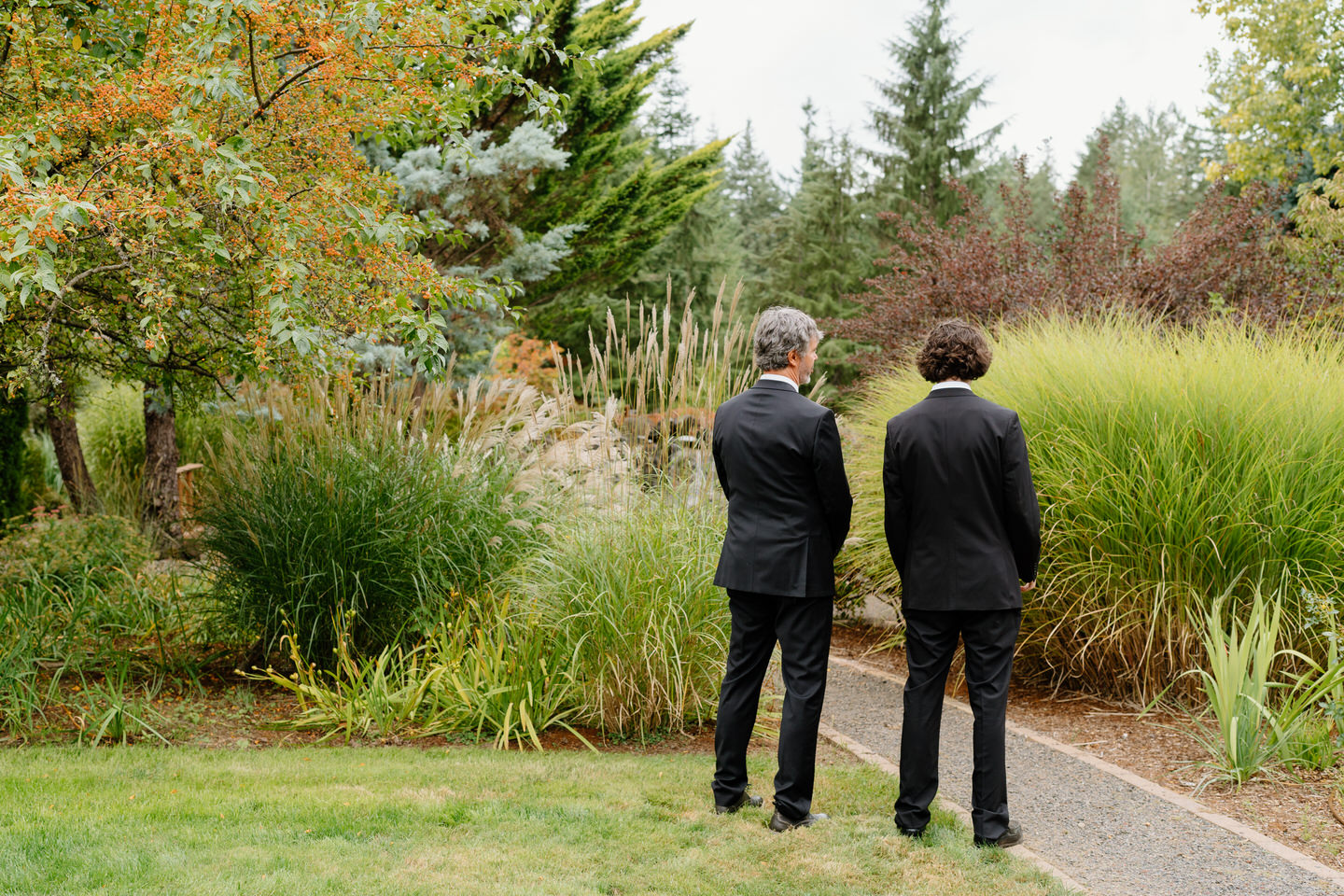 The father and brother of the bride face away before the first look with the bride.