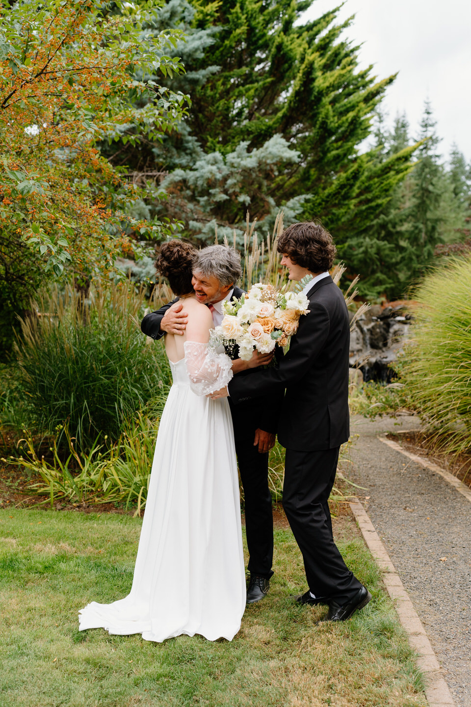 Bride and her father share a hug during first look at Navarra Gardens.