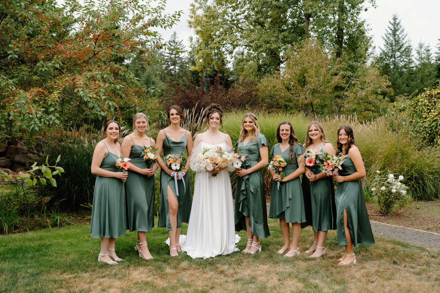 Bride and bridesmaids take their formal portraits in the garden at Navarra Gardens in Oregon.