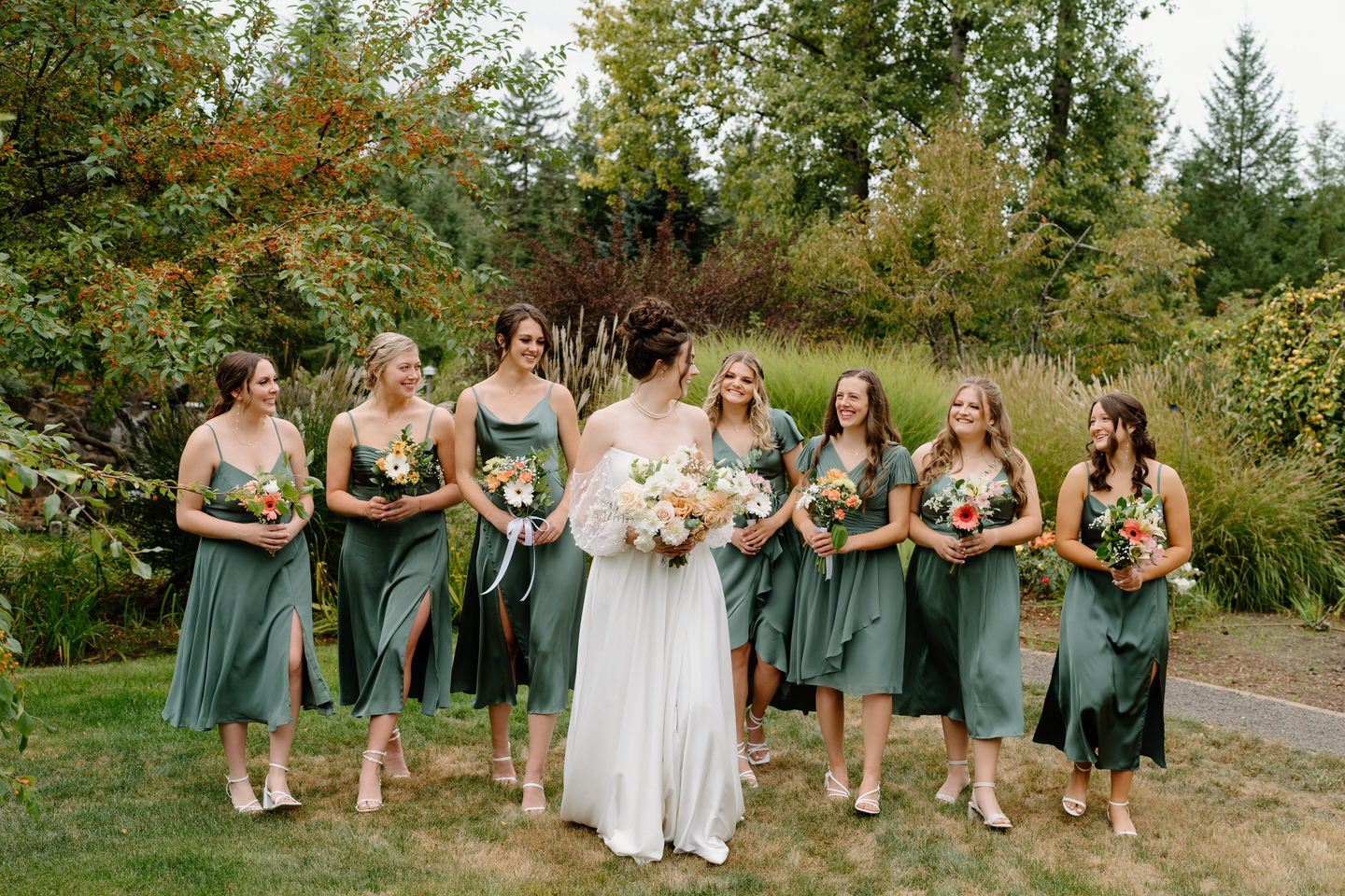 Bride and bridesmaids walk together as they prepare for a Pacific Northwest wedding ceremony.