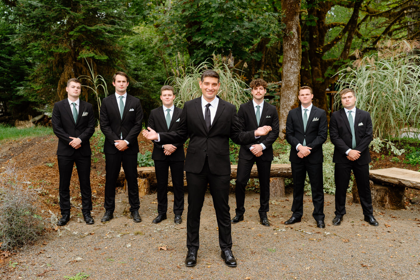 Groom stands in front of groomsmen before ceremony at Navarra Gardens.