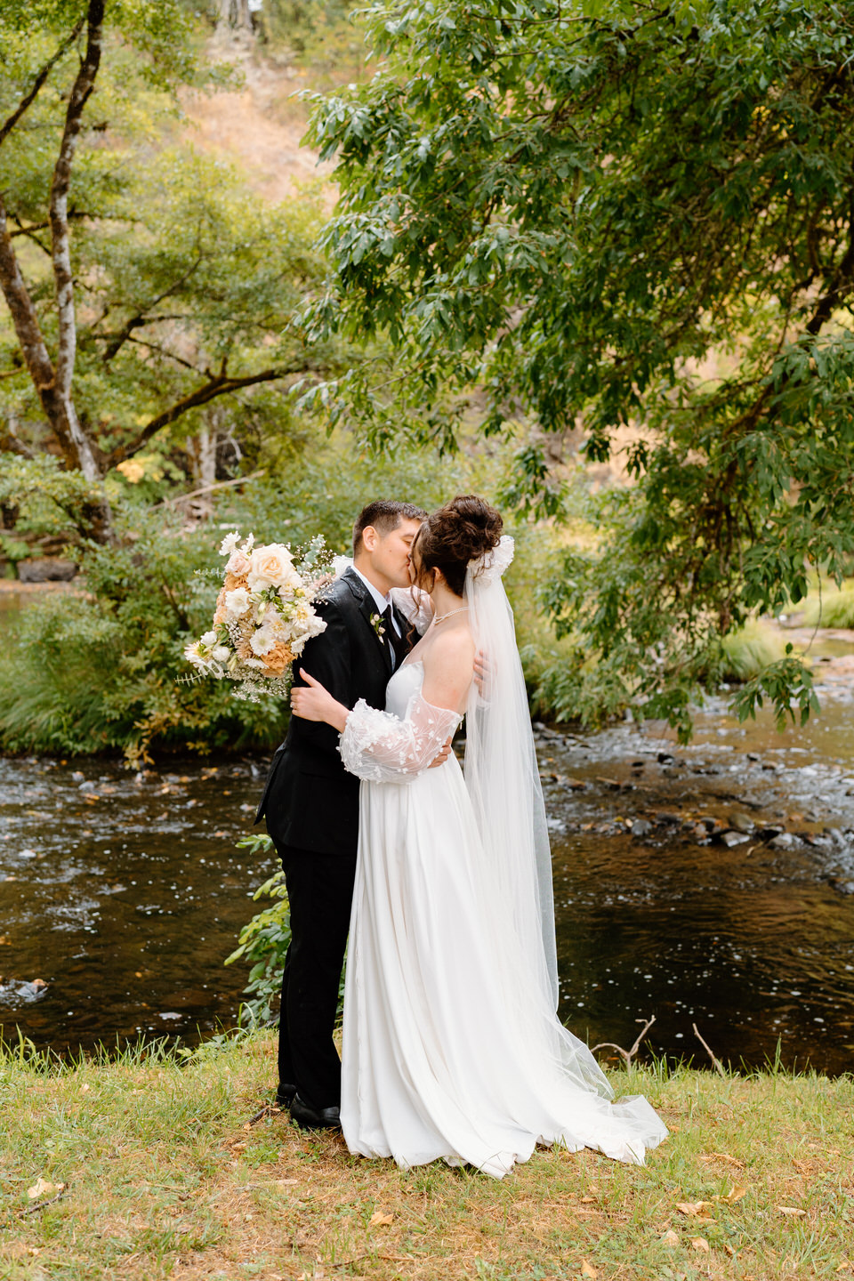 Couple kisses on their wedding day at Navarra Gardens in Oregon.