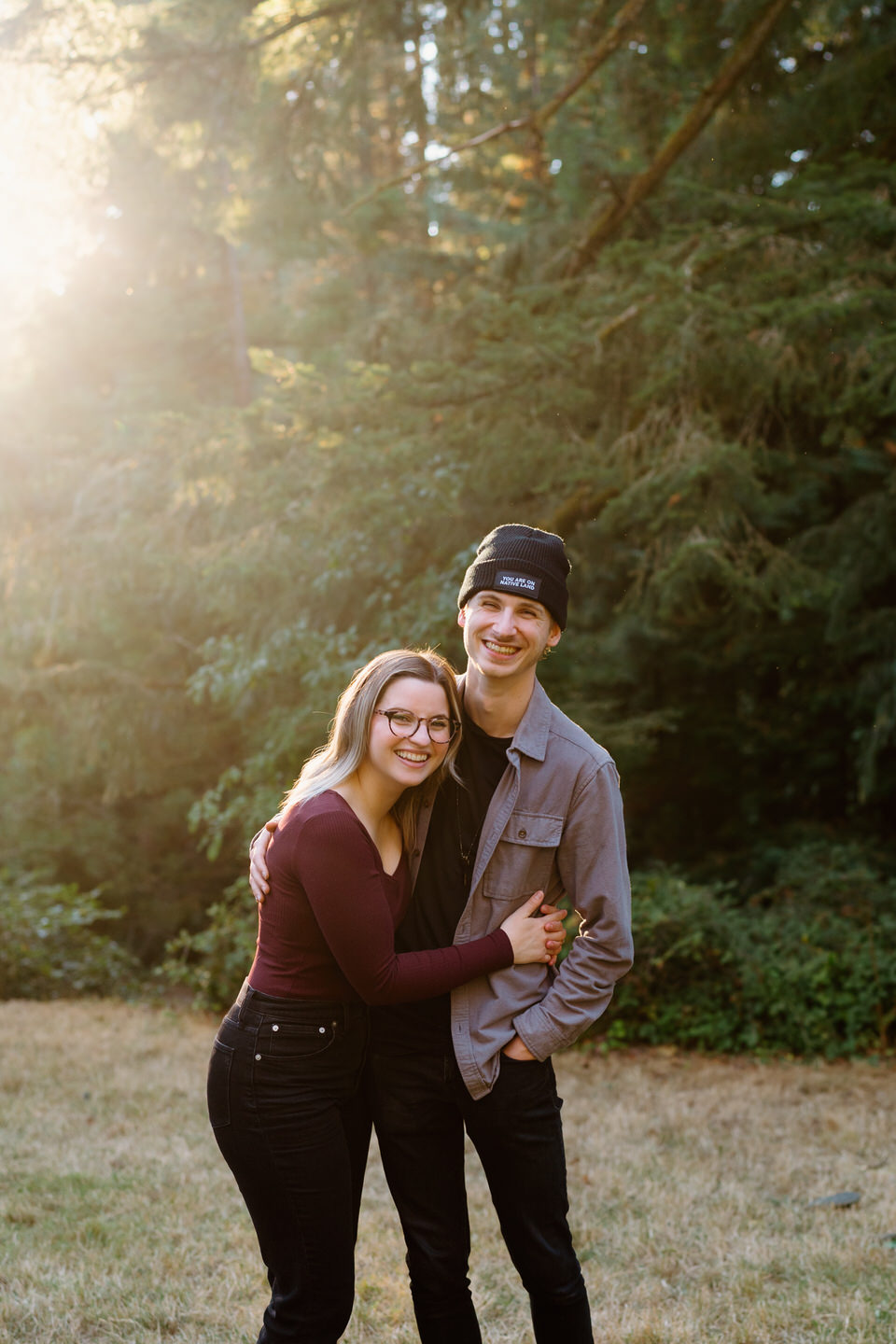 Fall engagement session in Portland, Oregon at Hoyt Arboretum. Golden hour light comes through behind couple in fall attire.