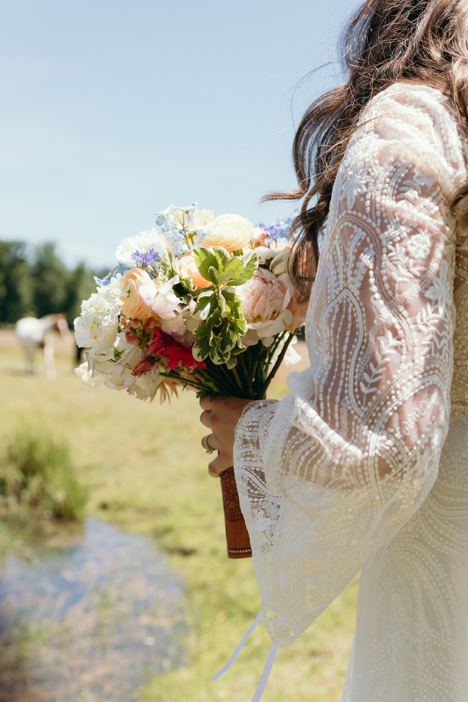 Bride holds her bouquet from Raybell Farms.