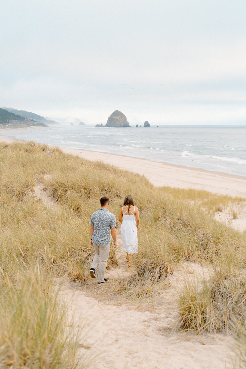 Couples photos in the beach grass on the Oregon Coast.