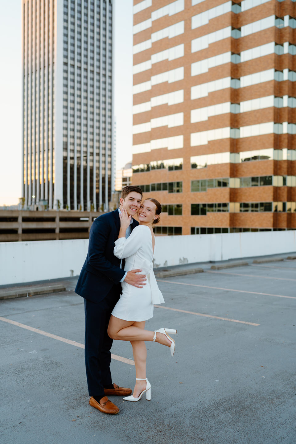 Couple posing on rooftop parking garage in Portland, Oregon.