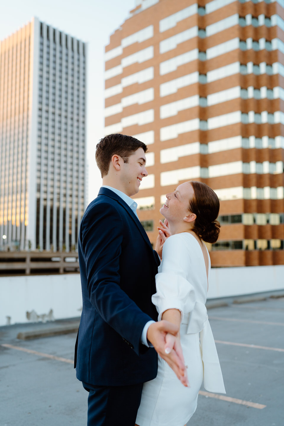 Couple holding hands on parking garage for engagement photos in Portland, Oregon. 