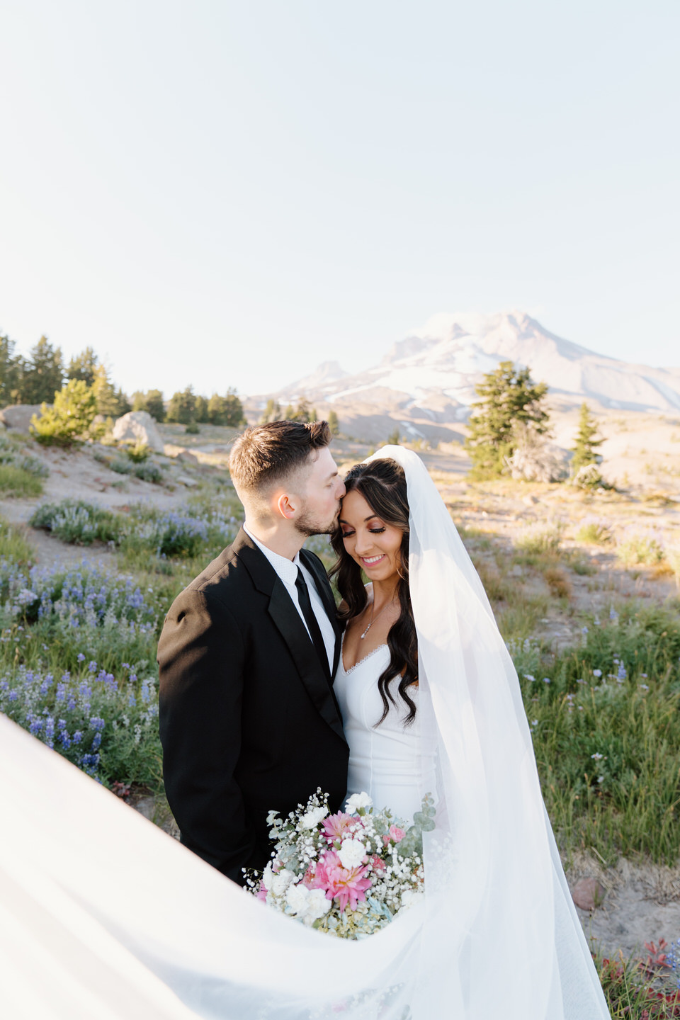 Bridal portraits at Timberline Lodge with wildflowers in August.