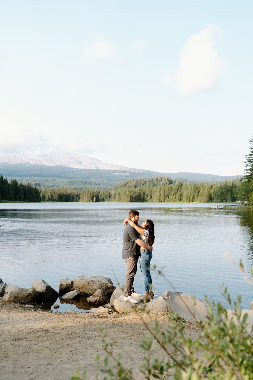 Couple with arms wrapped around each other for Oregon engagement photos near Mt. Hood.