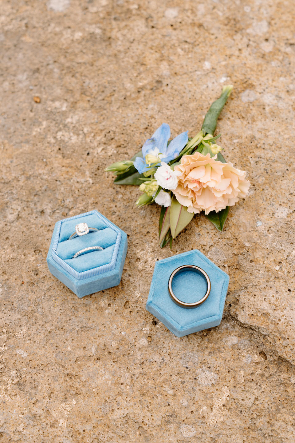 Close up photo of wedding rings and flowers for Aspen Lakes Golf Course wedding.