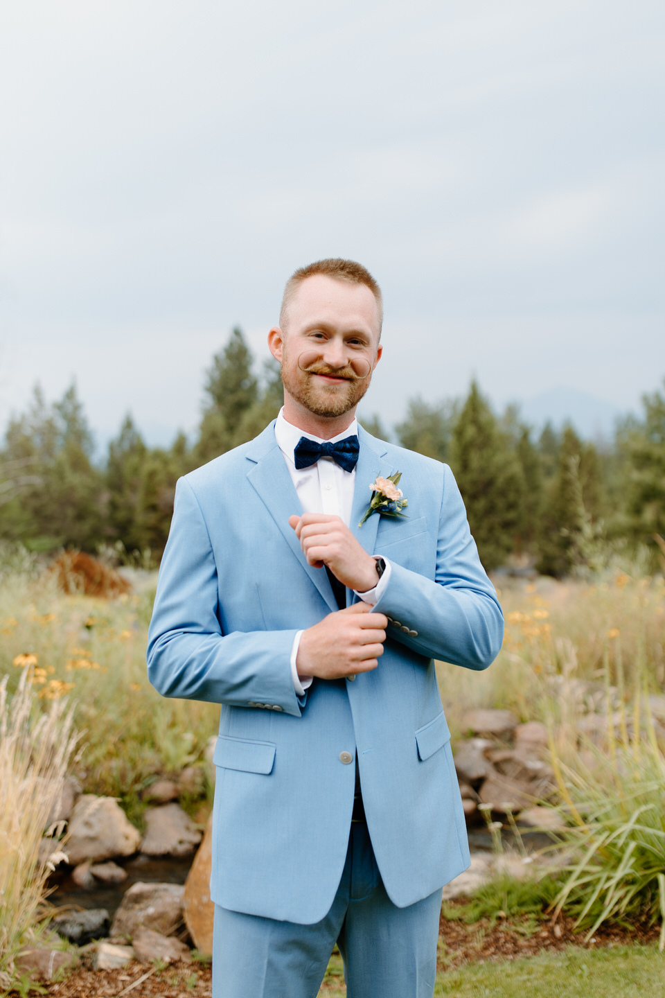 Groom wedding portraits with groom in blue suit