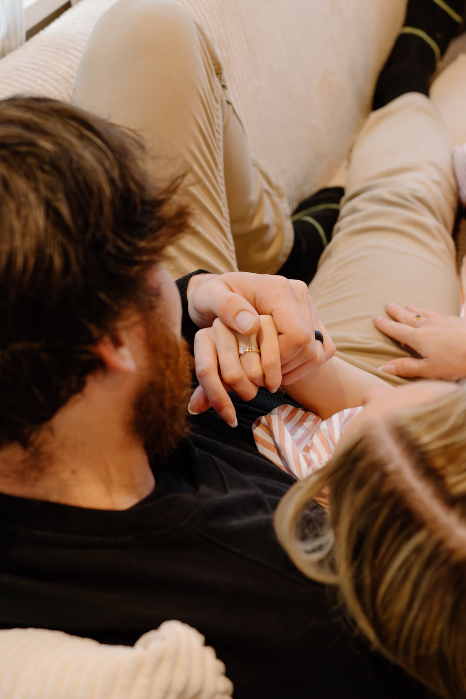 Close up on couple holding hands with wedding rings