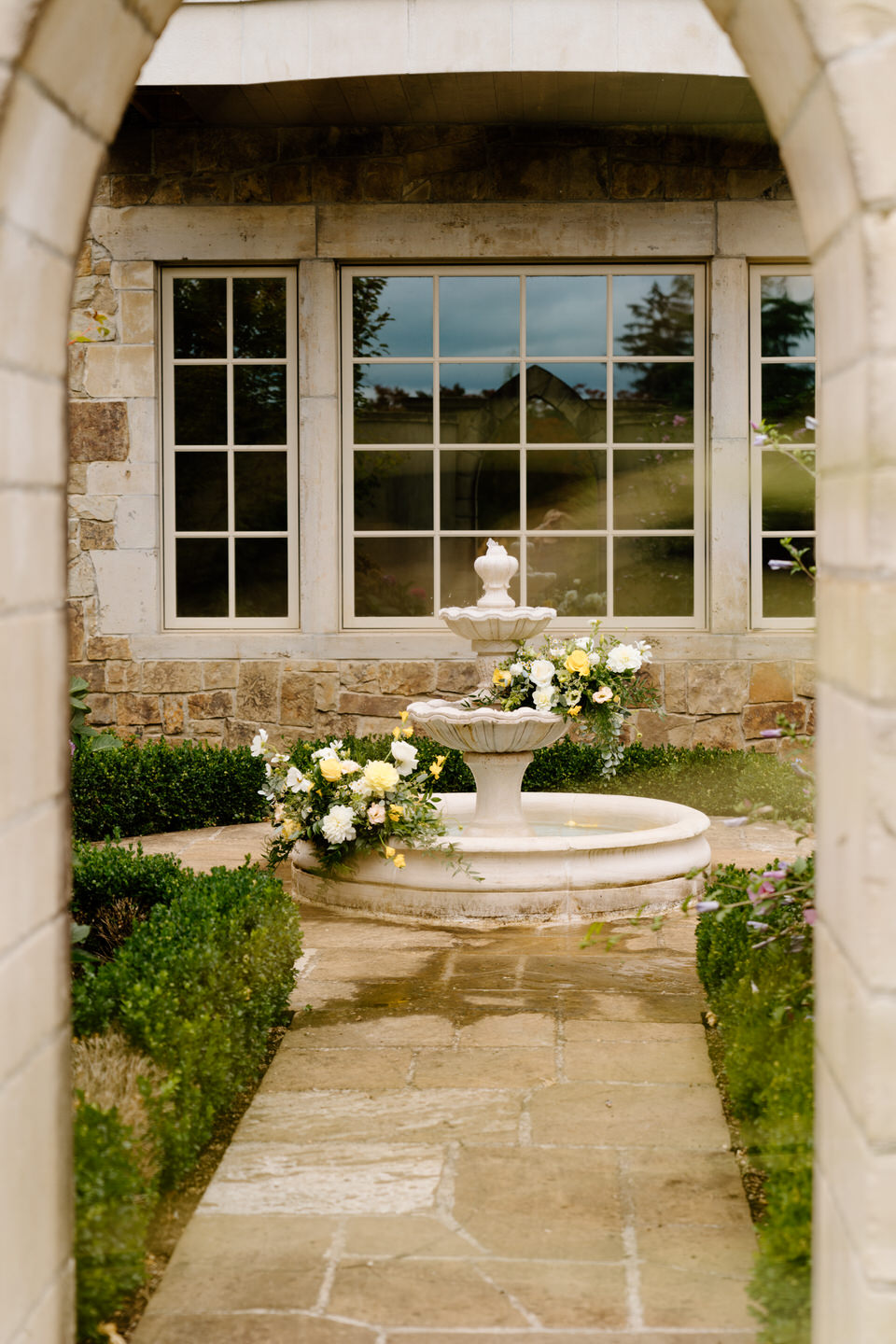 Tuscan inspired floral installation in the fountain at Chateau de Lis